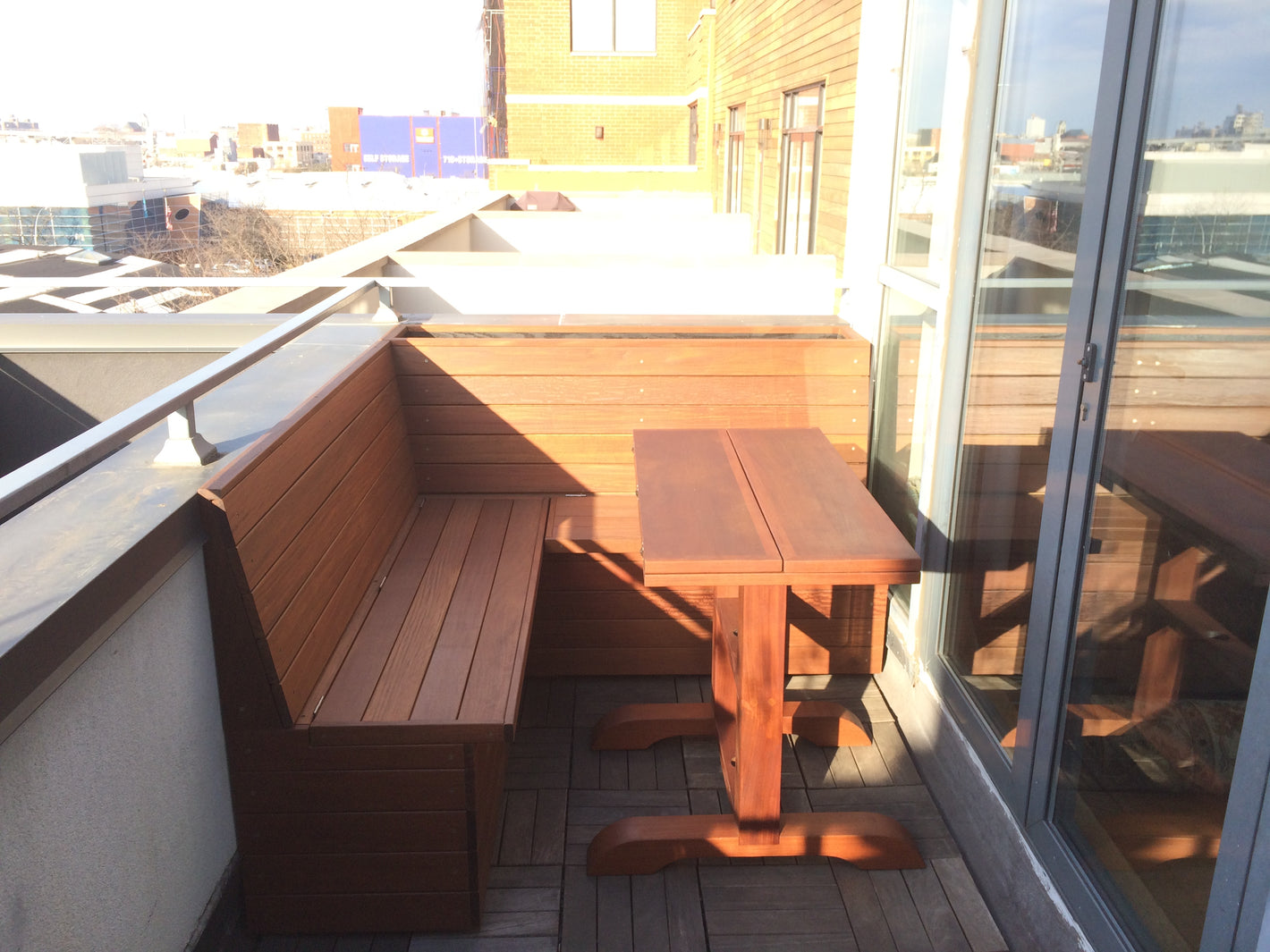 Custom ipe bench with a custom ipe folding table on a terrace created by TCSC
