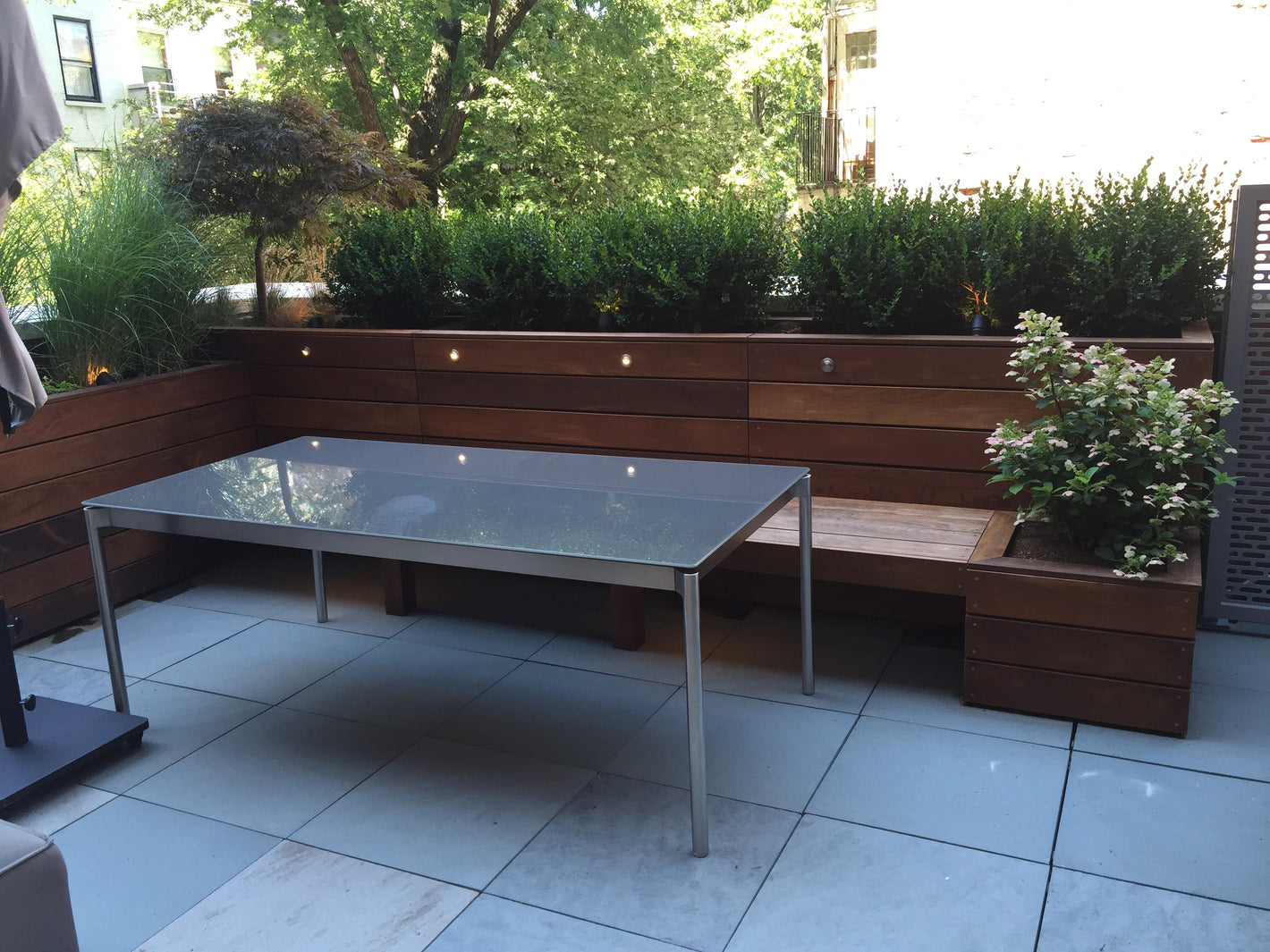 Custom outdoor ipe bench with planters and outdoor lighting created by TCSC