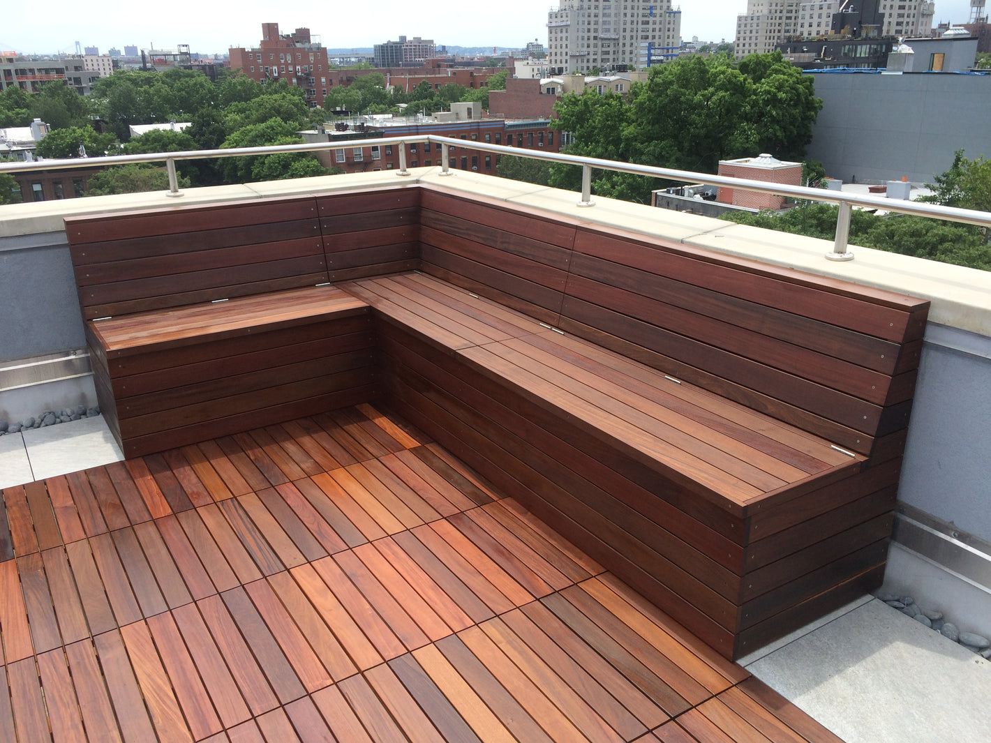 Custom outdoor rooftop bench with slanted back and ipe deck tiles created by TCSC