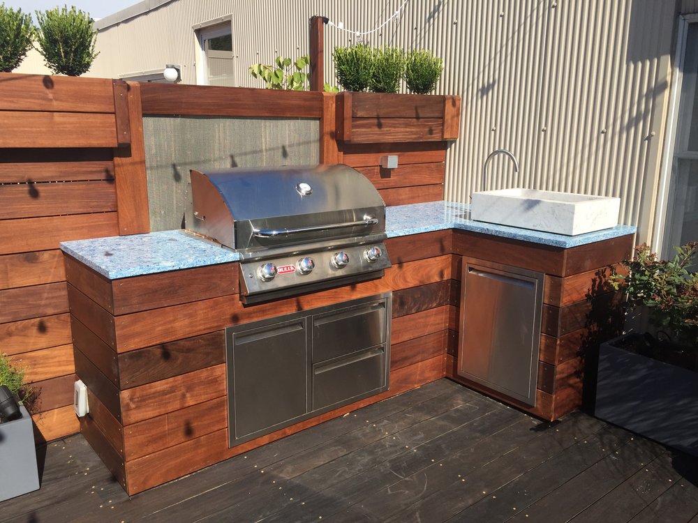 Backyard outdoor kitchen with custom sky blue granite countertop created by TCSC