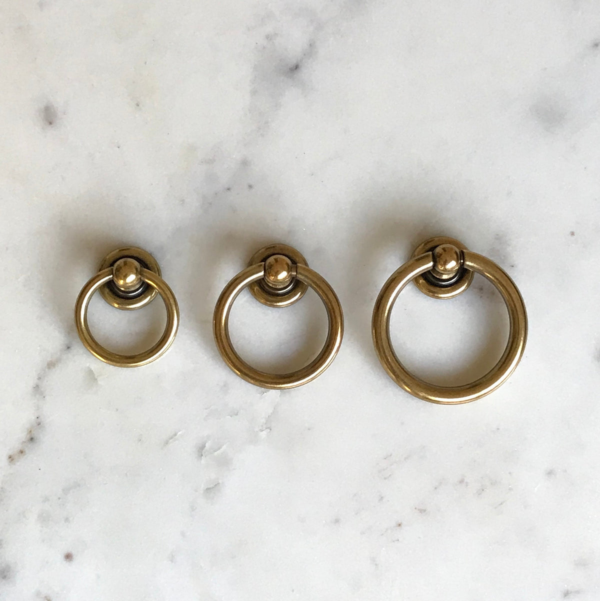 Plain Antique Brass "Capri" Ring Drawer Pulls.