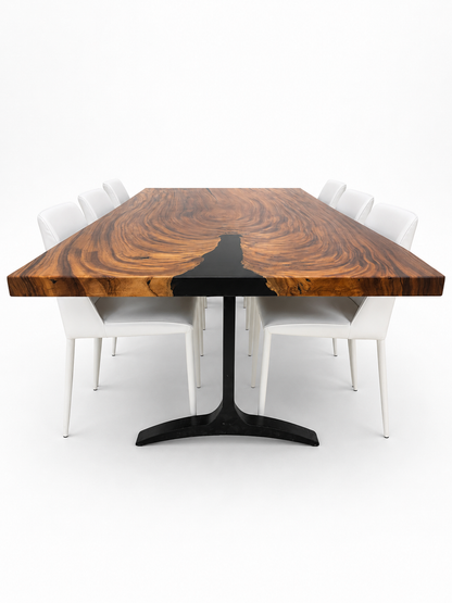 Dining table with a wooden top and black base, surrounded by white chairs on a white background