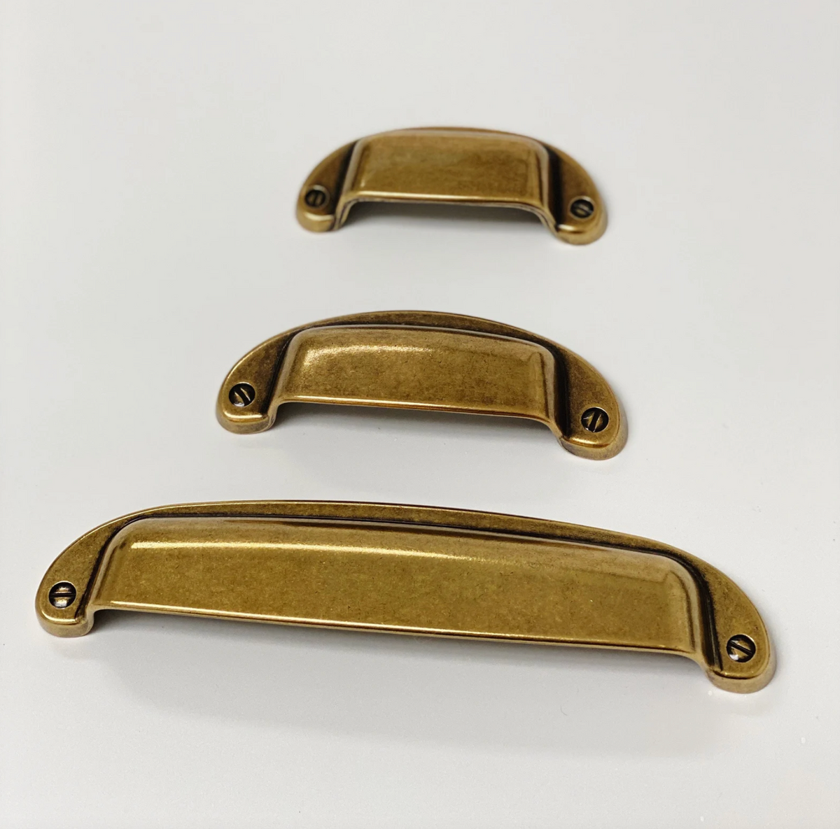 Drawer Cup Pull "Capri" in Antique Brass.