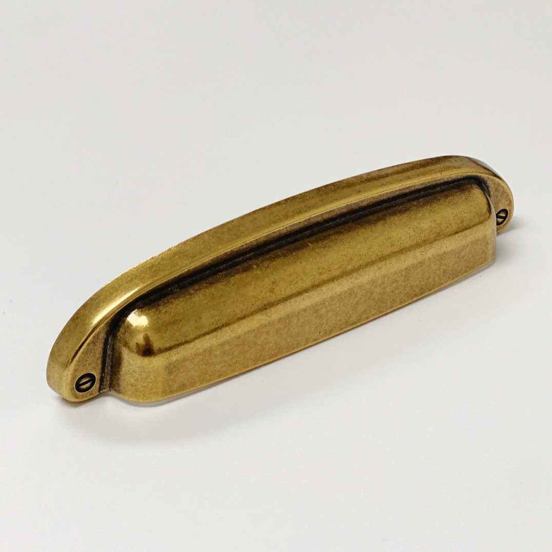 Drawer Cup Pull "Capri" in Antique Brass.