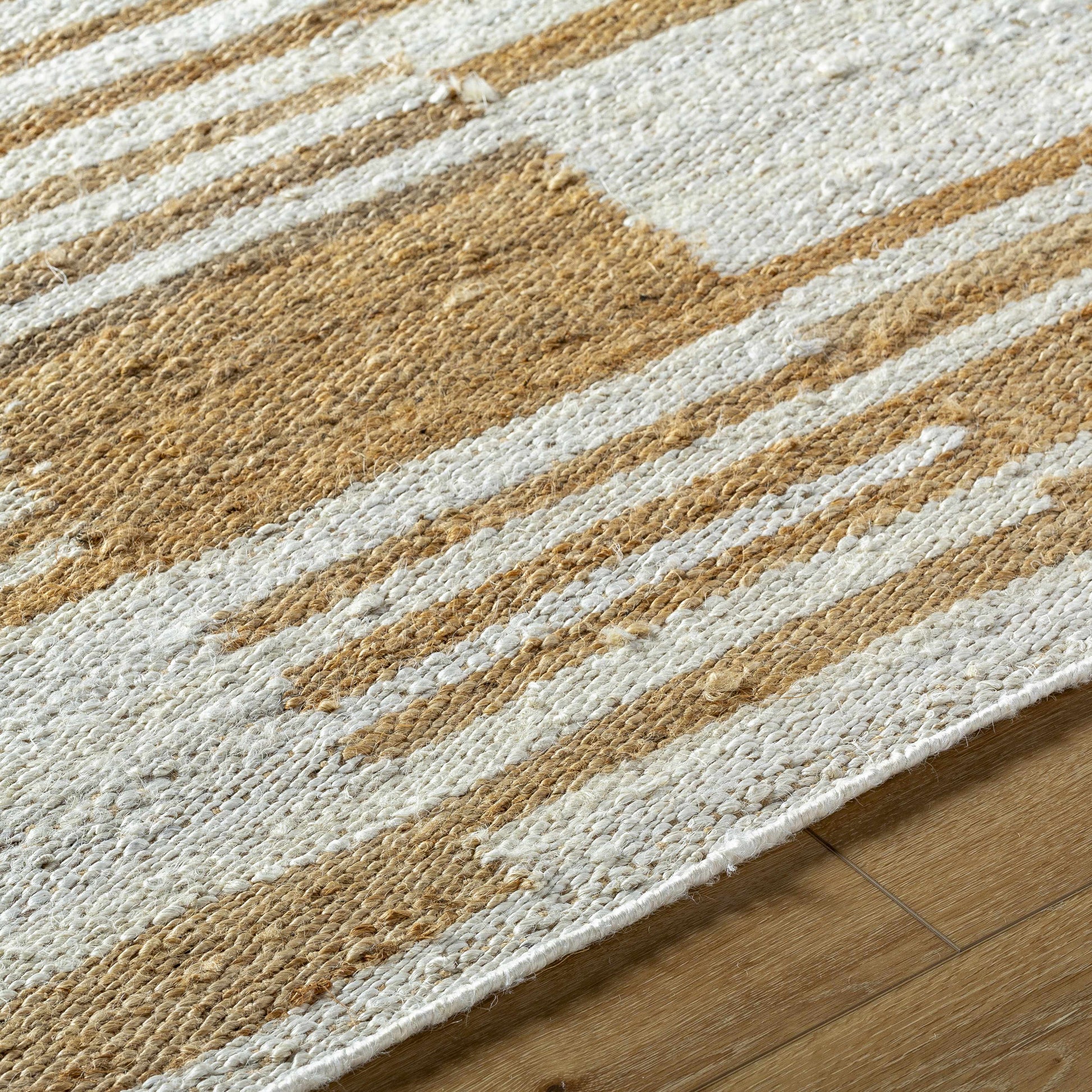 Close-up of a textured rug with brown and beige stripes on a wooden floor.
