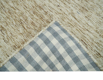 Beige and Ivory Modern Solid Hand Woven Wool Rug.