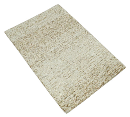 Beige and Ivory Modern Solid Hand Woven Wool Rug.