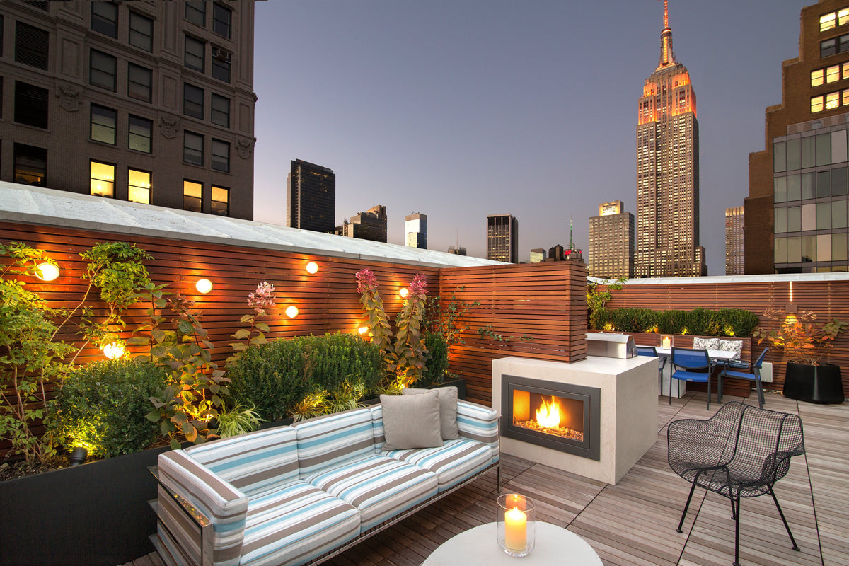 Roof top patio with seating area and city skyline view