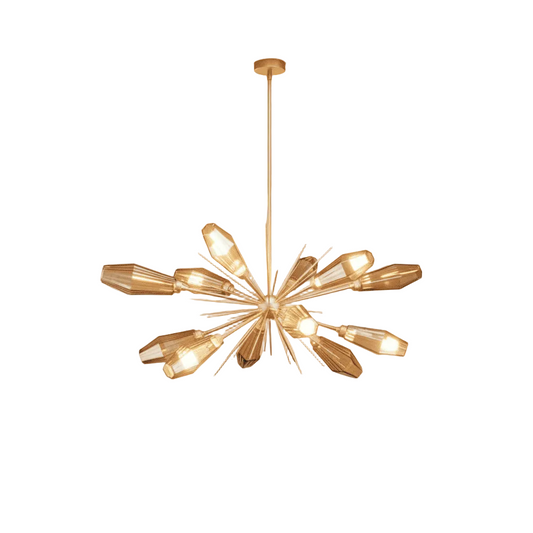 Gold chandelier hanging against a beige wall