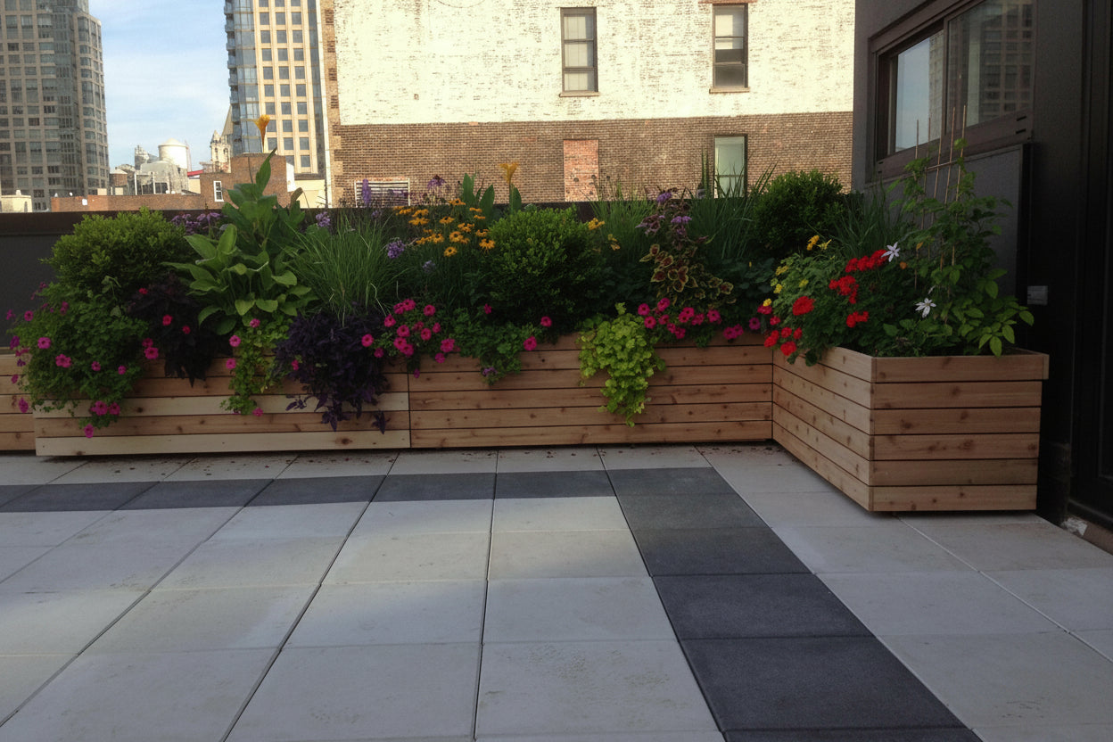 Wooden outdoor seating area on a rooftop with cityscape in the background
