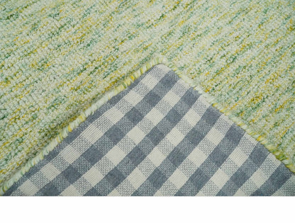 Custom Made Solid Green And Ivory Hand Tufted Natural Wool Area Rug.
