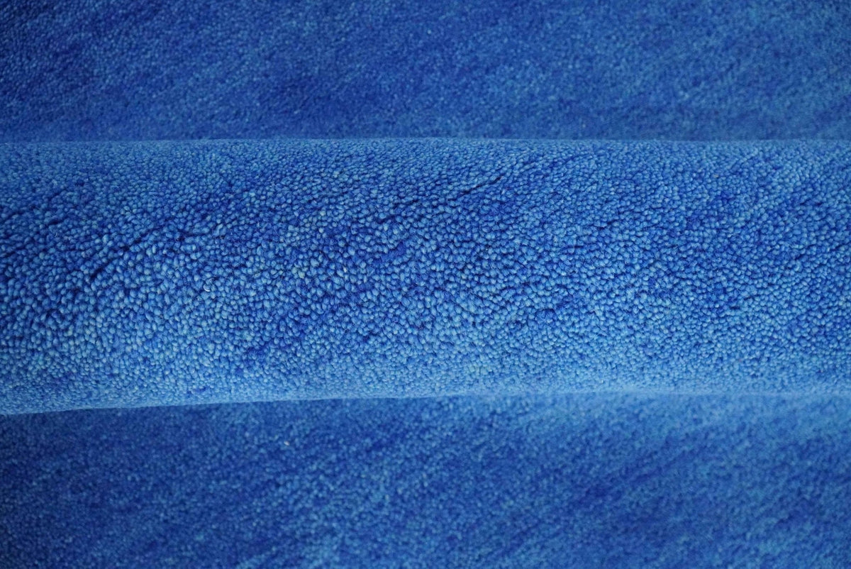 Custom made solid Blue Woolen Hand Tufted contemporary area Rug.