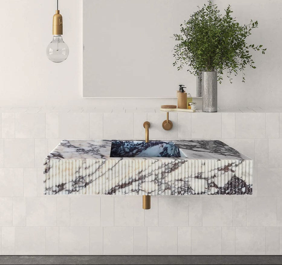 Modern bathroom with a marble sink and decorative elements.