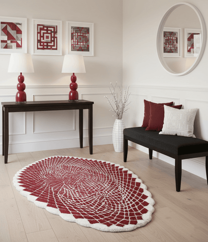 Living room with a red and white patterned rug, black bench, and red lamps.